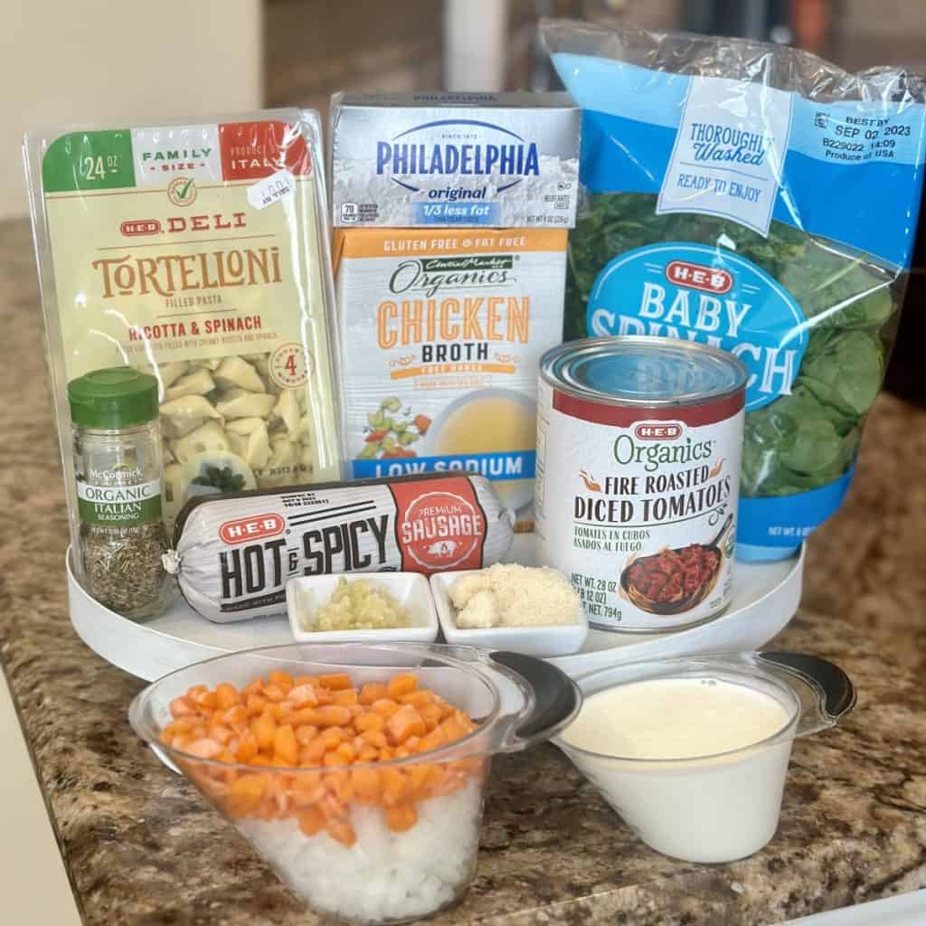 The ingredients to make italian sausage tortellini soup.