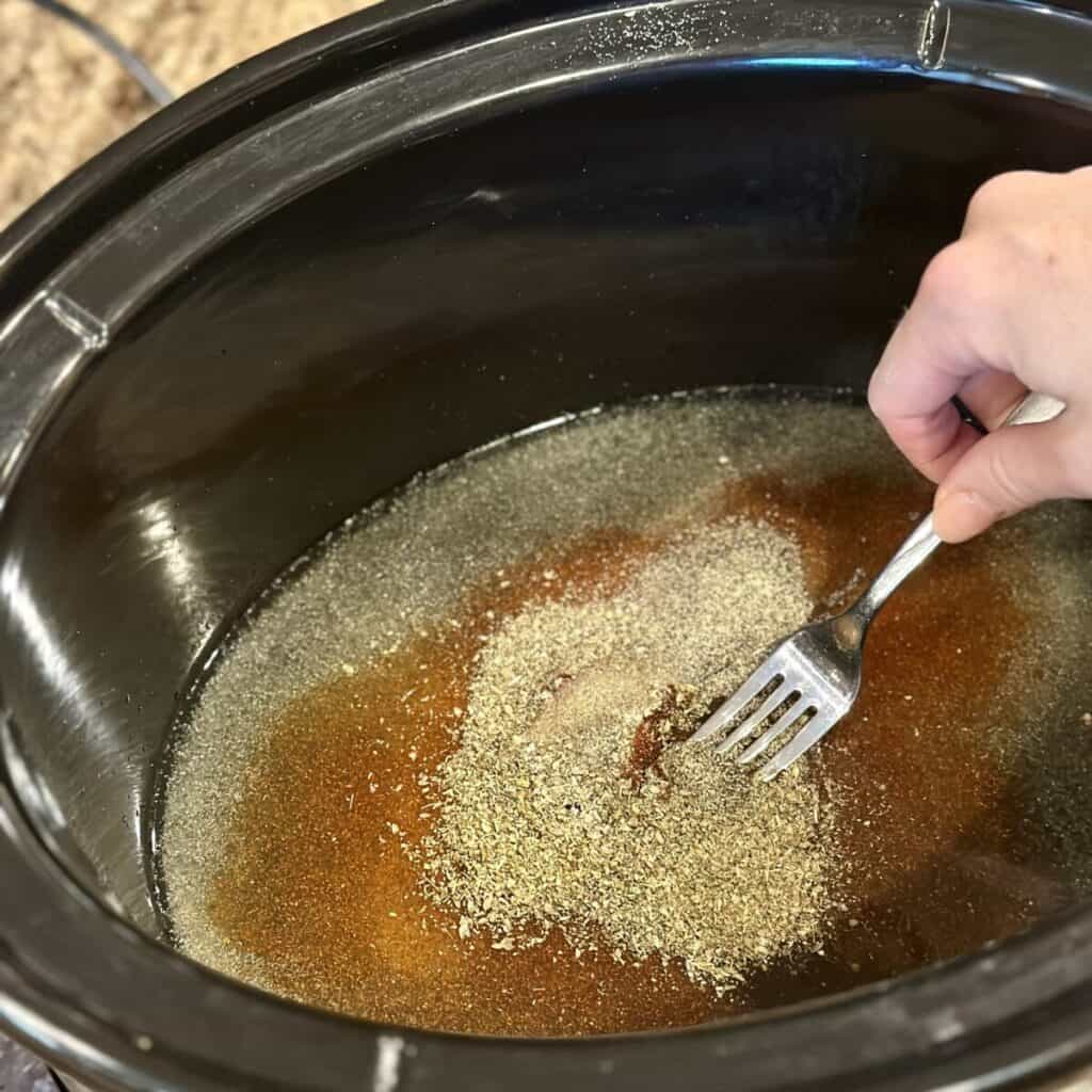 Mixing together liquid in a crockpot.