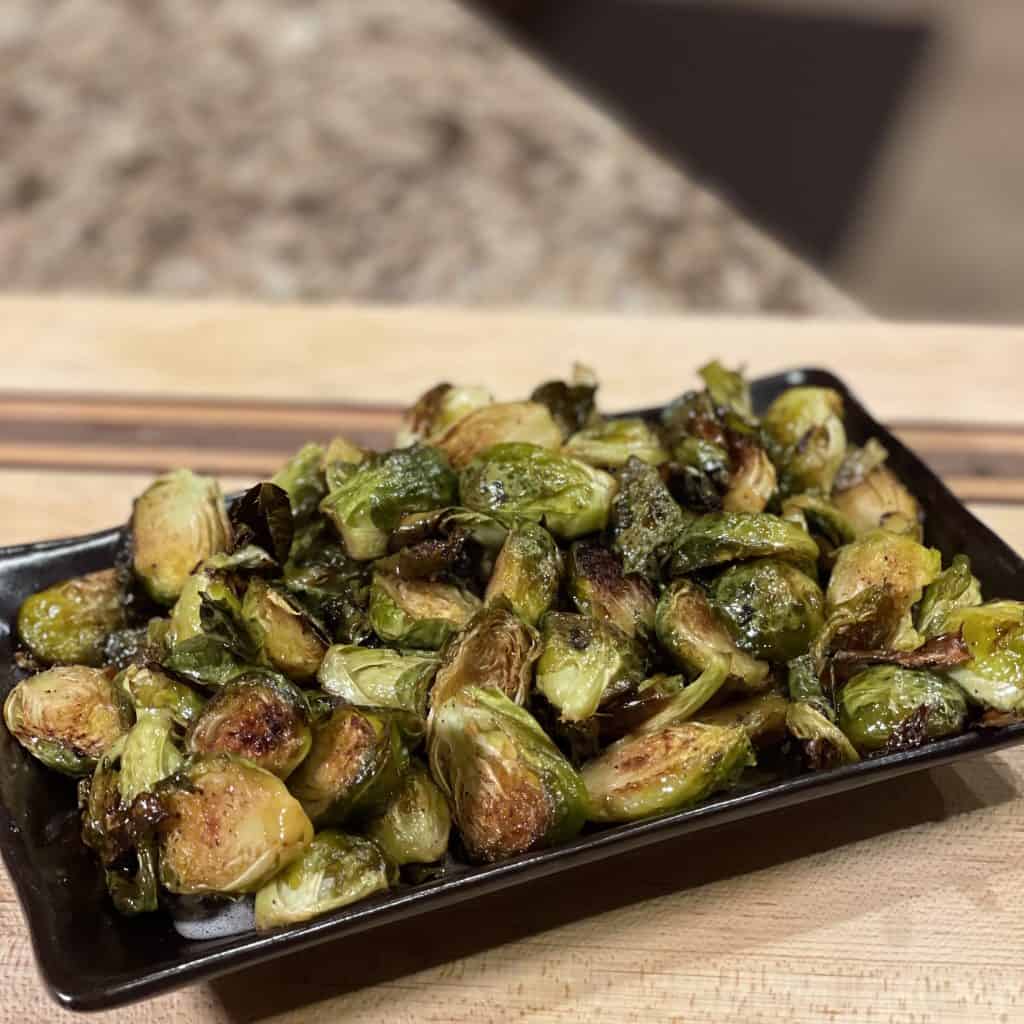 This is a picture of a plate of roasted Brussels sprouts.