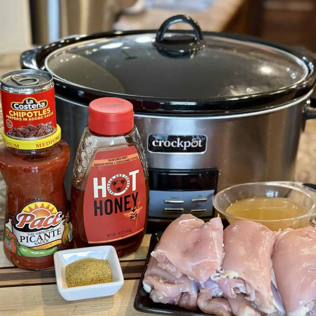 a Crockpot and the ingredients for sweet and spicy chicken