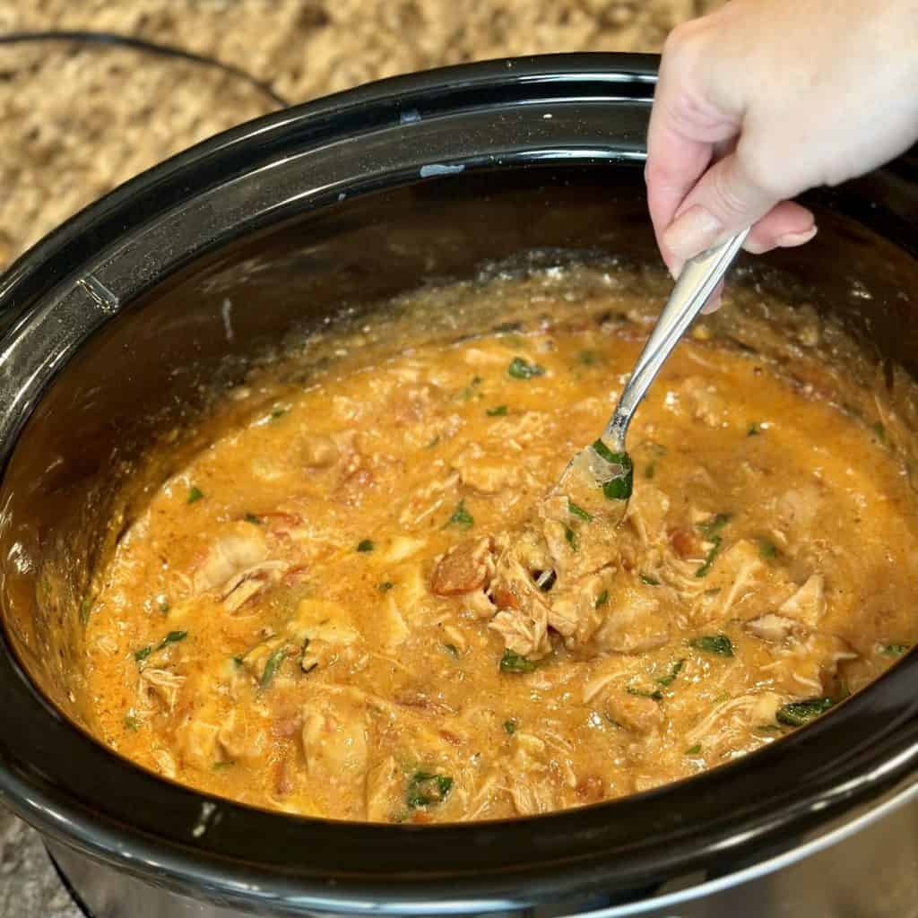 Mixing together ingredients in a crockpot.