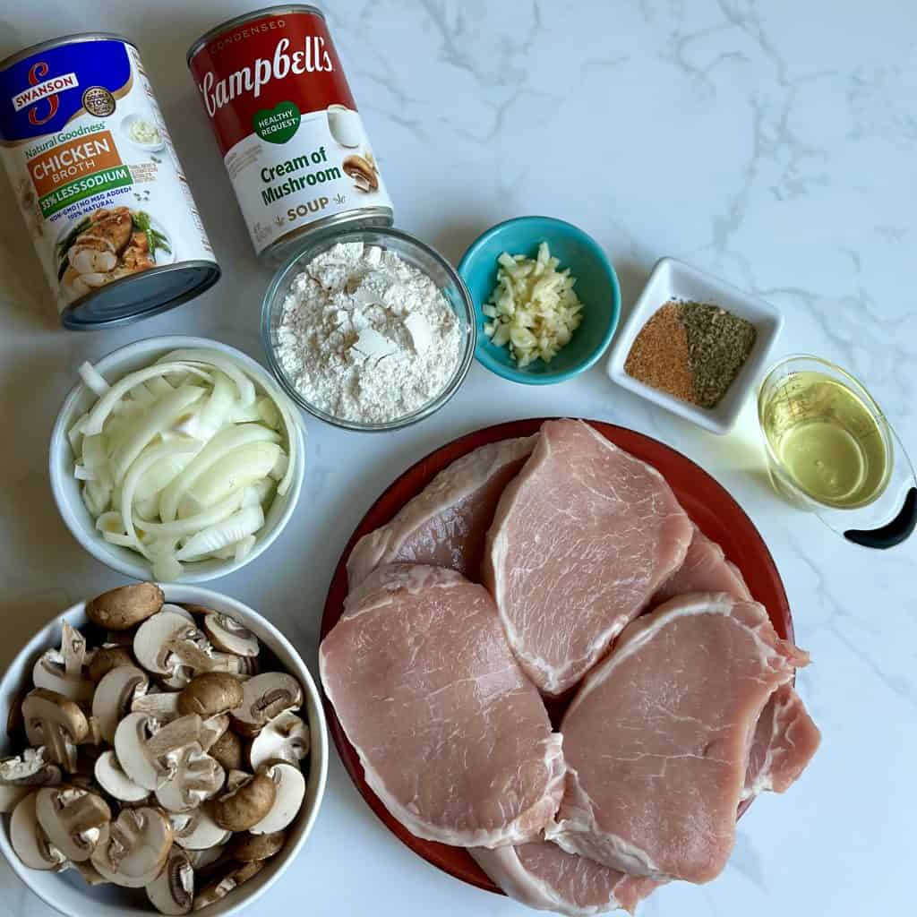ingredients for smothered porkchops are shown on a countertop