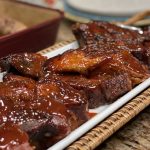 This is a picture of a plate of barbecue glazed pork ribs.