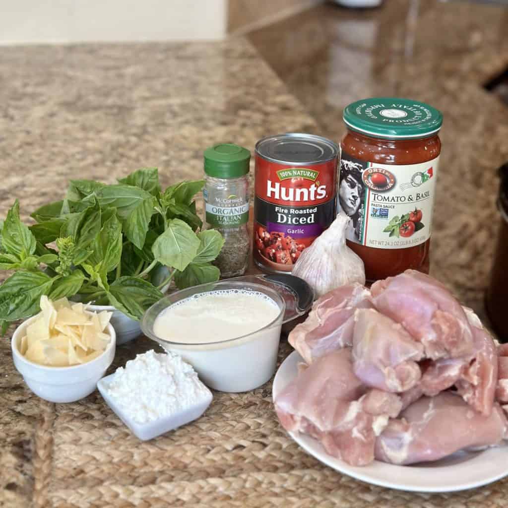 The ingredients to make a crockpot tomato basil chicken.