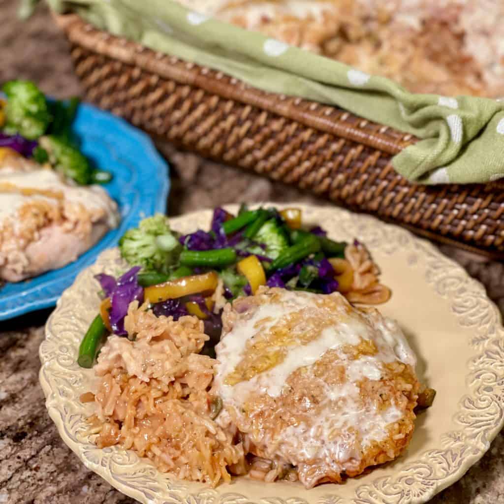 plate of queso chicken, rice and small salad