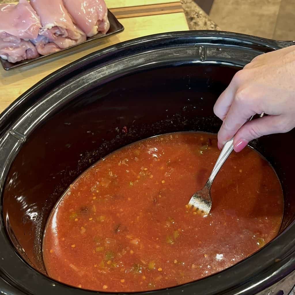 mixing ingredients together in a slow cooker