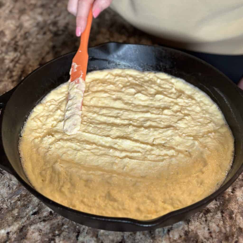 spreading dough mixture into pan