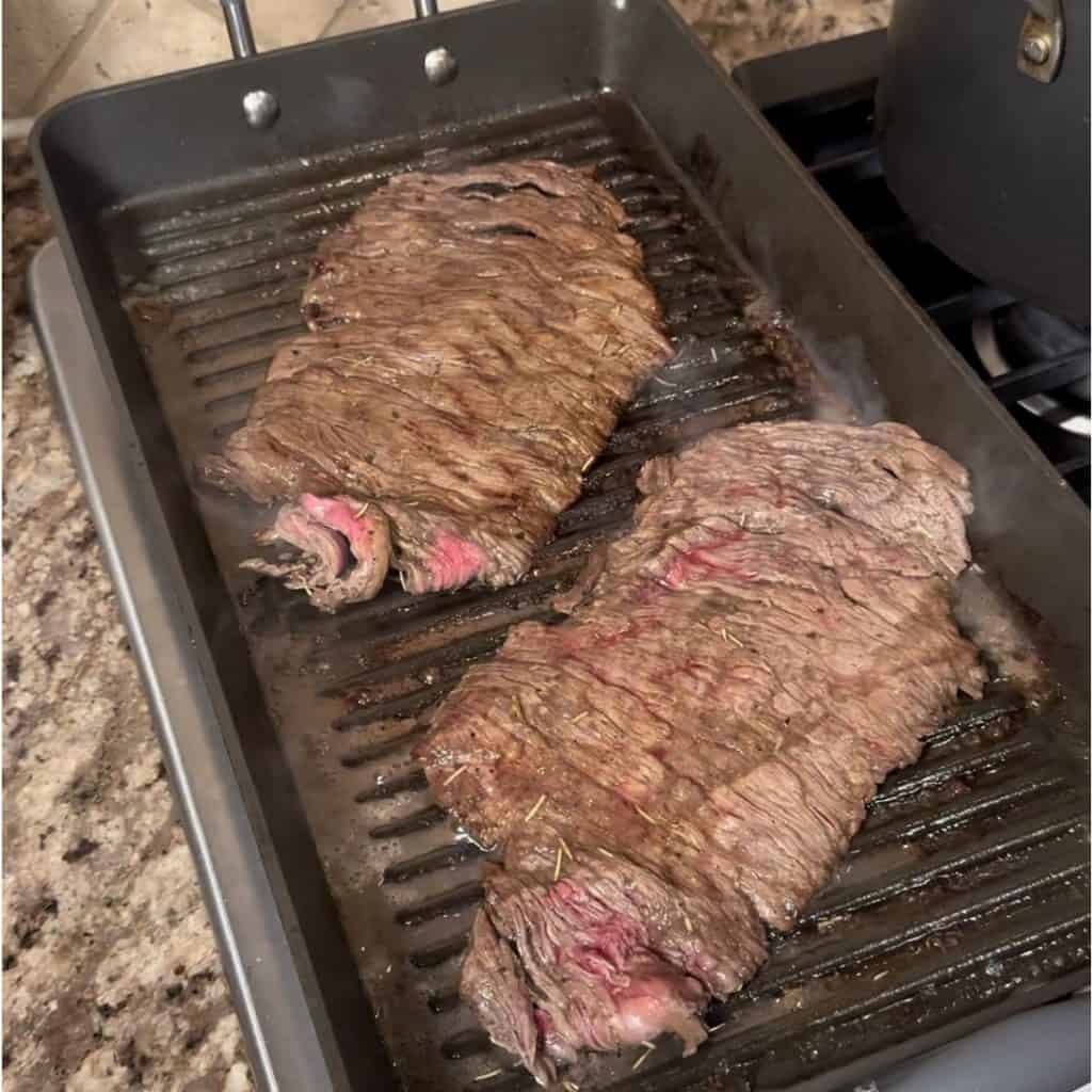 searing flank steak on a grill pan