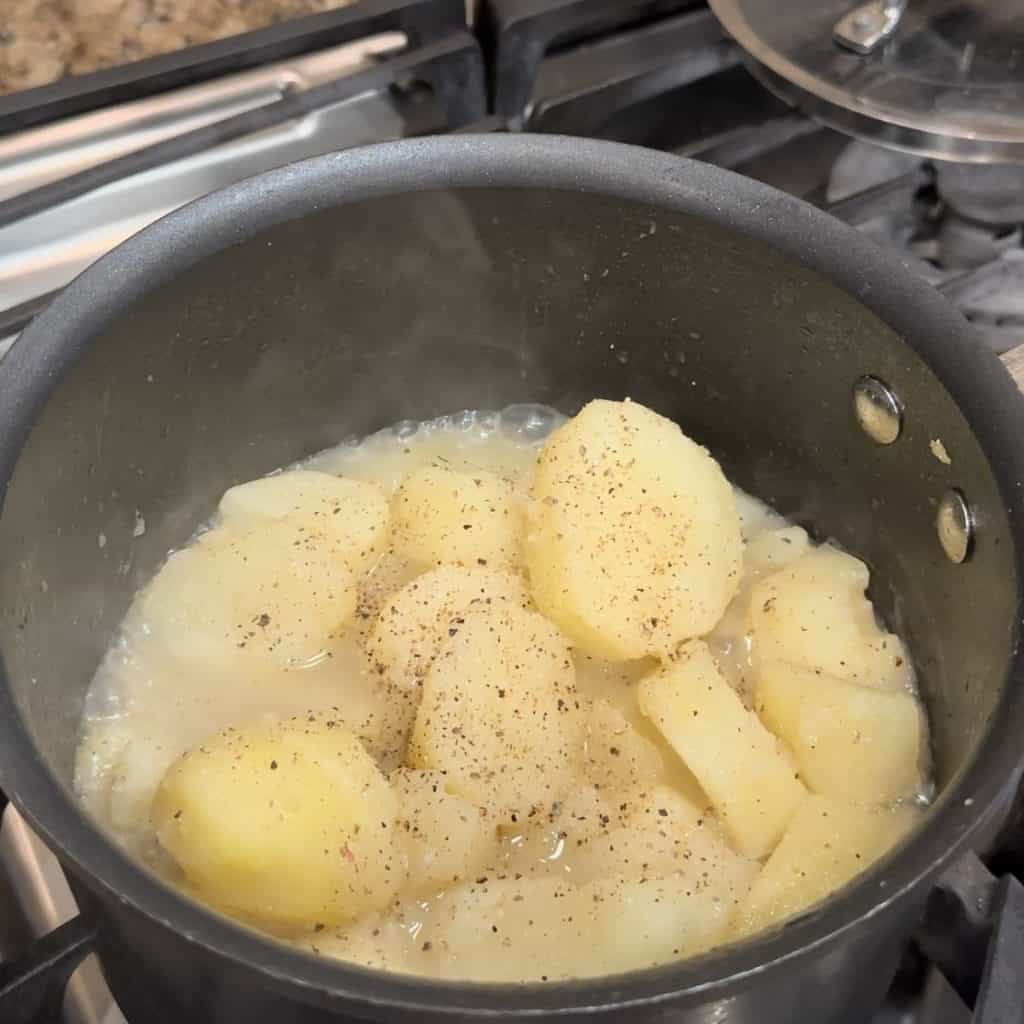 seasoned potatoes cooking in a pot