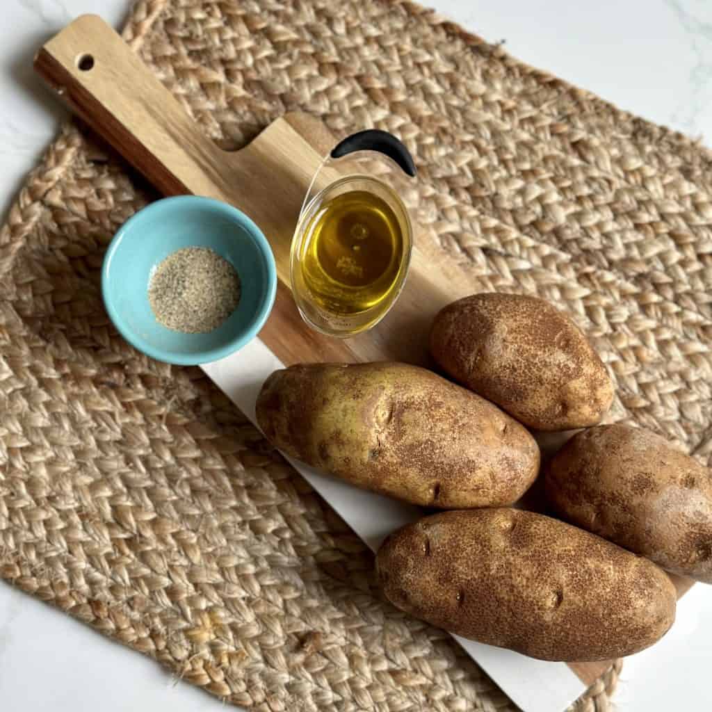 potatoes with seasoning and oil on the side on a table