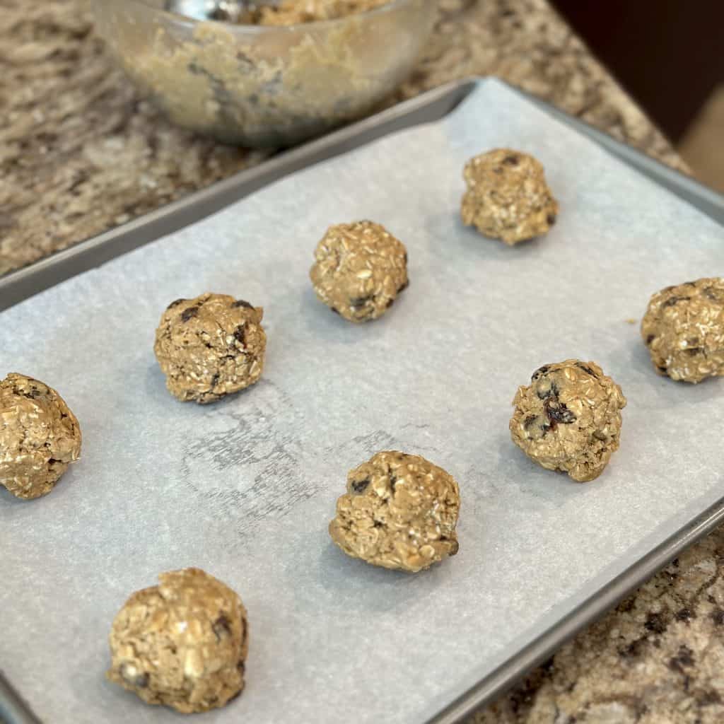 oatmeal raisin cookie dough balls ready to go in the oven