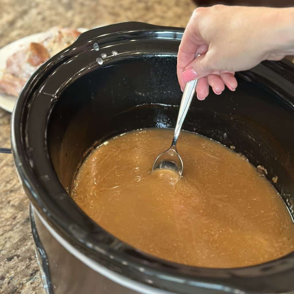 testing the gravy for flavor and consistency