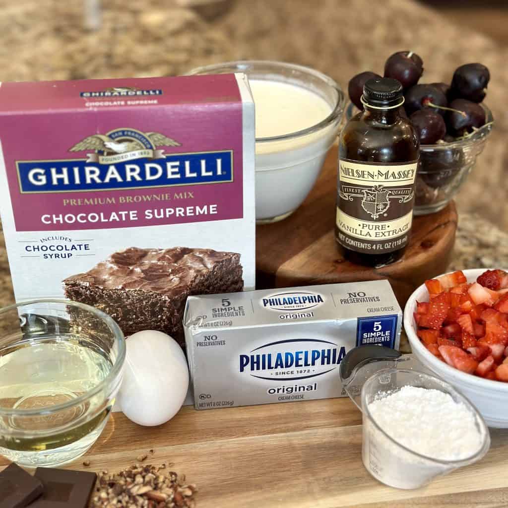ingredients for brownie pizza displayed on a cutting board