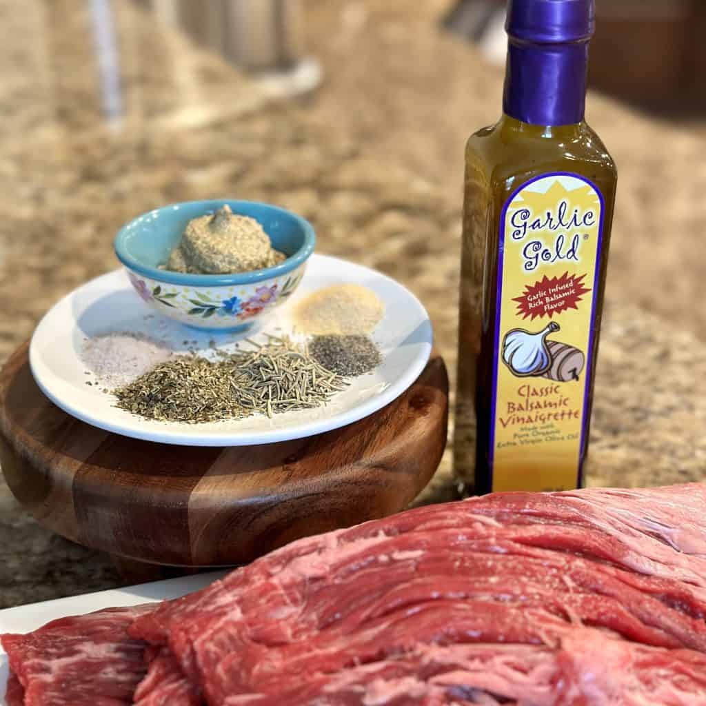 raw flank steak with ingredients for marinating 