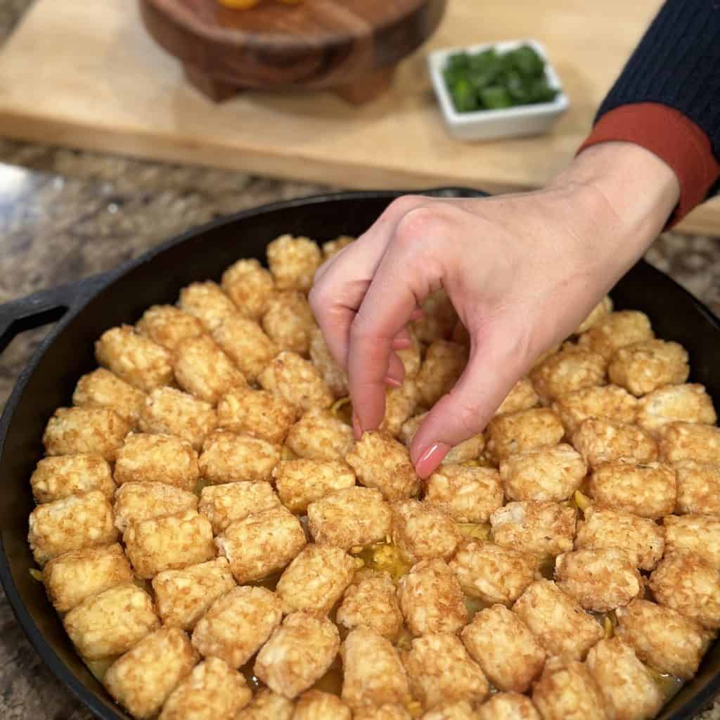 covering the casserole with tater tots