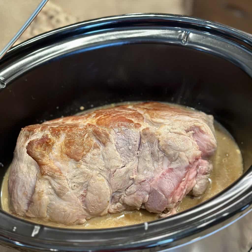 the pork roast is added to the crockpot
