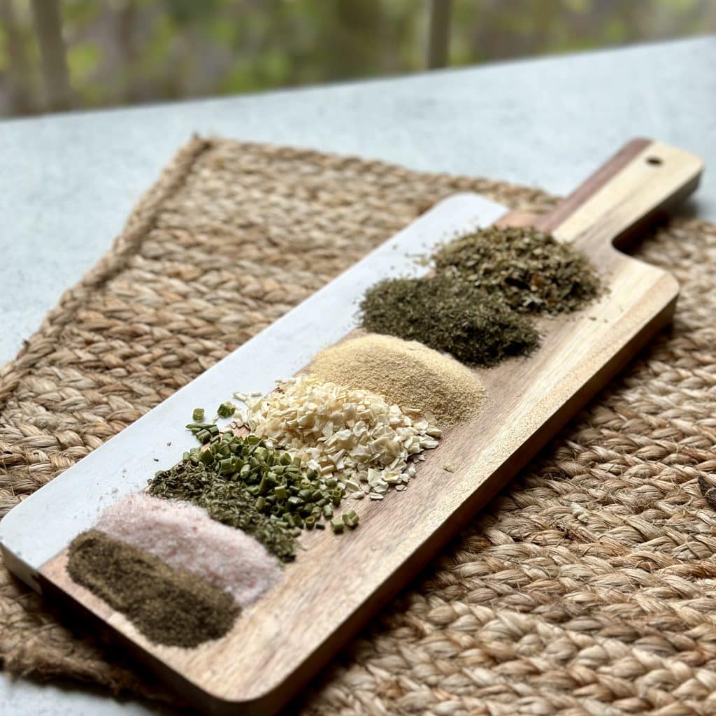 Ranch seasoning ingredients displayed on a decorative cutting board