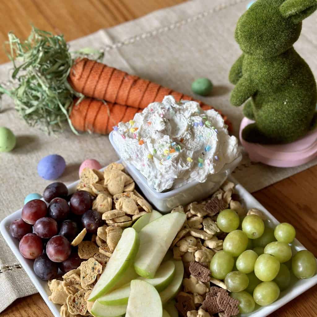 Cake batter sprinkle dip on a serving plate with fresh fruit and crackers