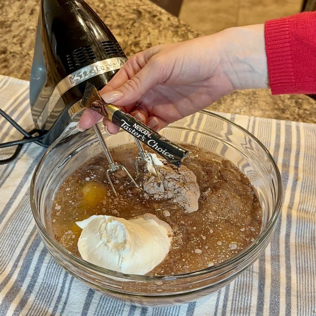 Using a hand mixer to combine cake mix ingredients and instant coffee