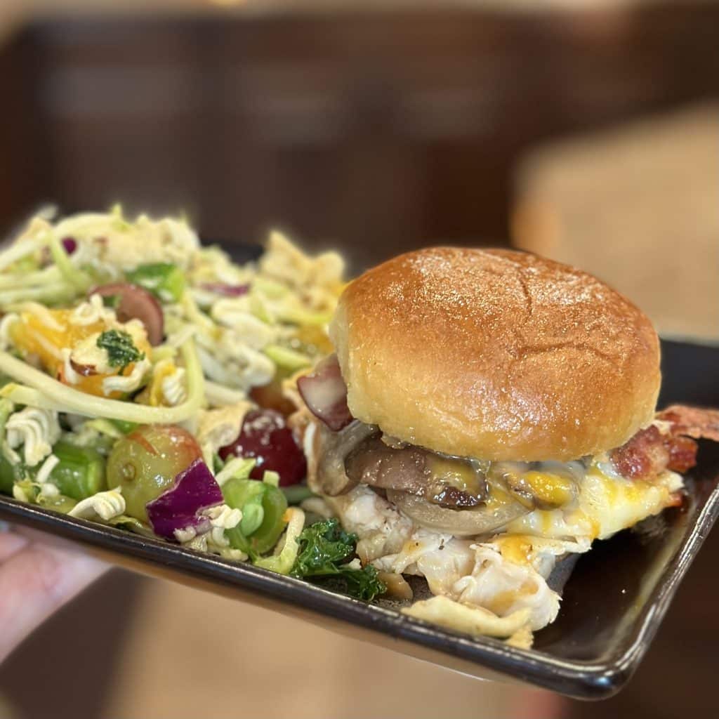 plated chicken slider sandwich with a salad on the side