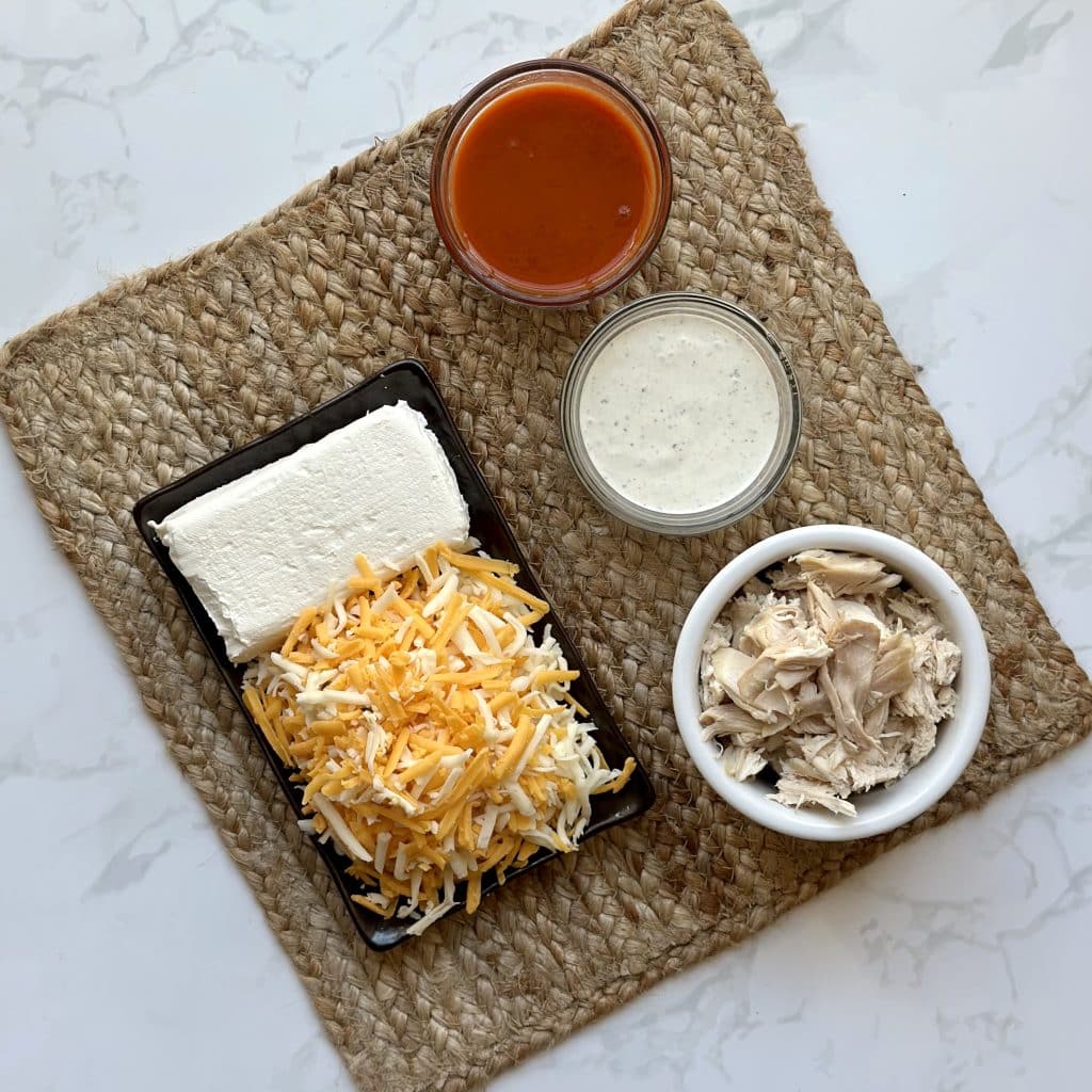 ingredients for Cheesy Buffalo Chicken displayed on a decorative mat.