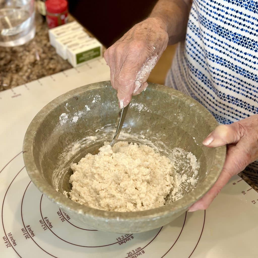 stirring dough in a bowl