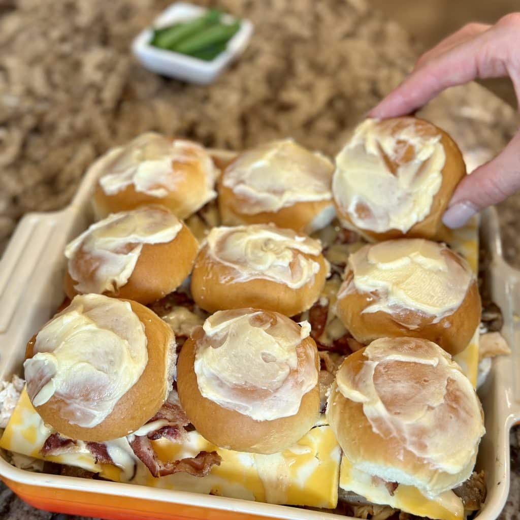 finished sandwiches in a baking dish with butter on top