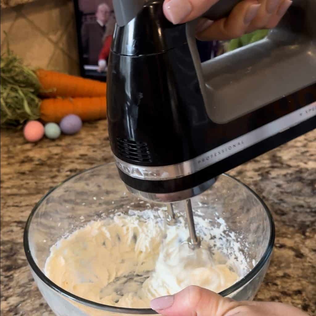 using a hand mixer to combine ingredients