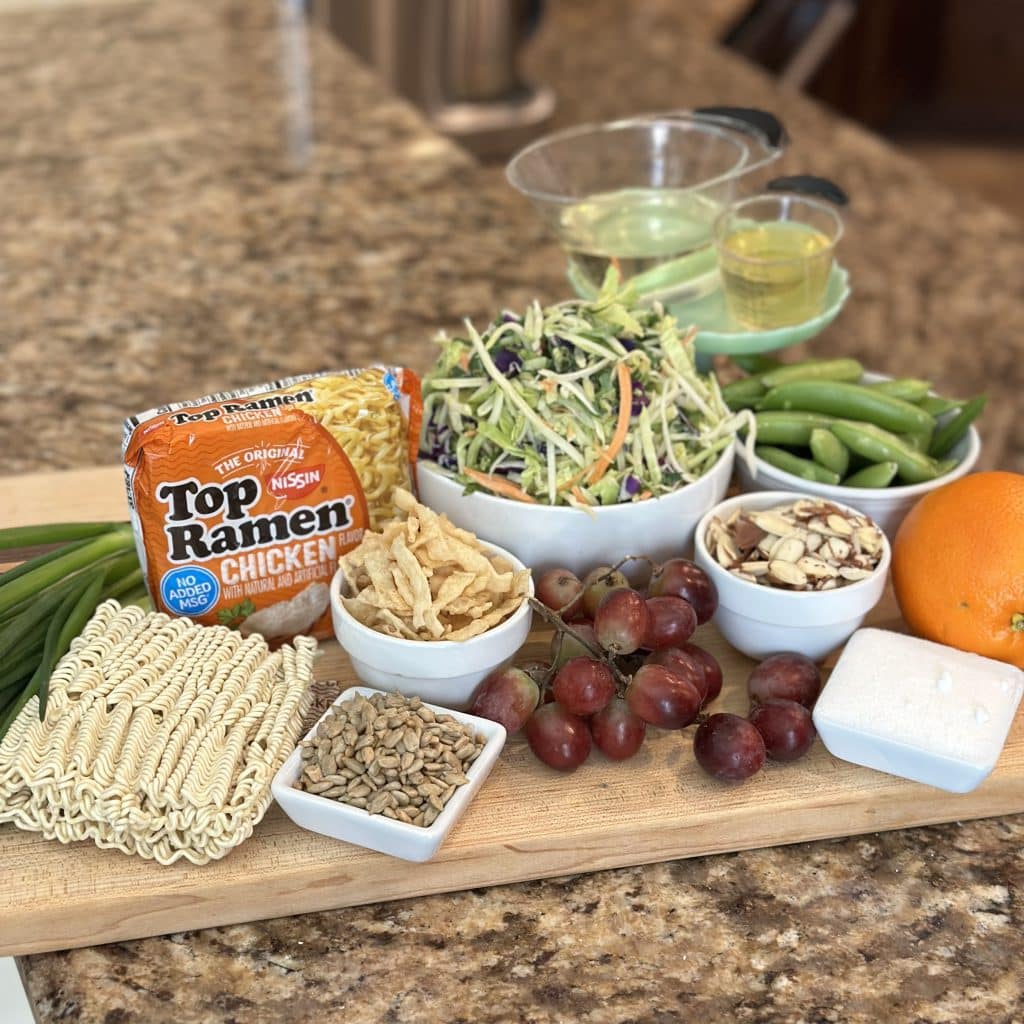 ingredients for crunchy ramen salad laid out on a cutting board