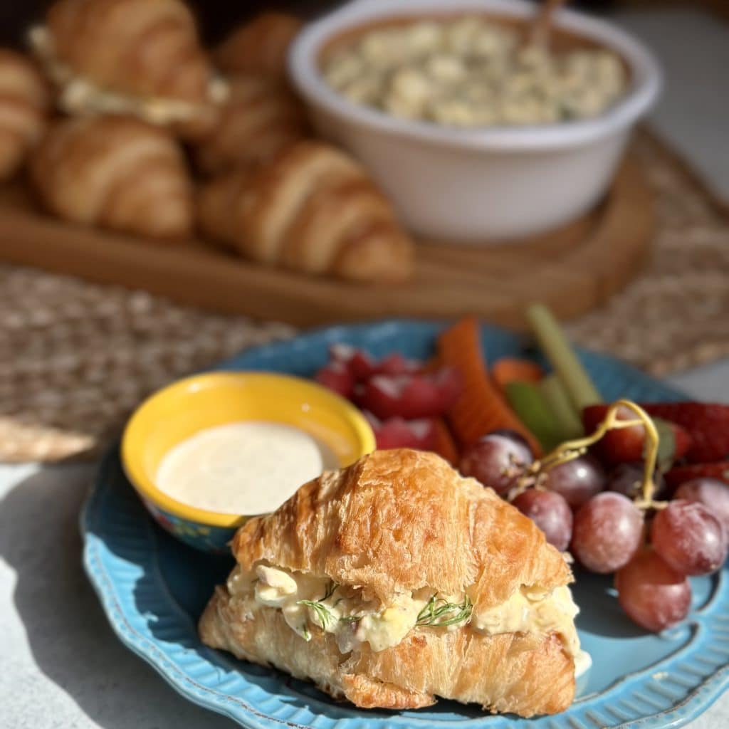 Served on a croissant sandwich with fresh veggies and grapes