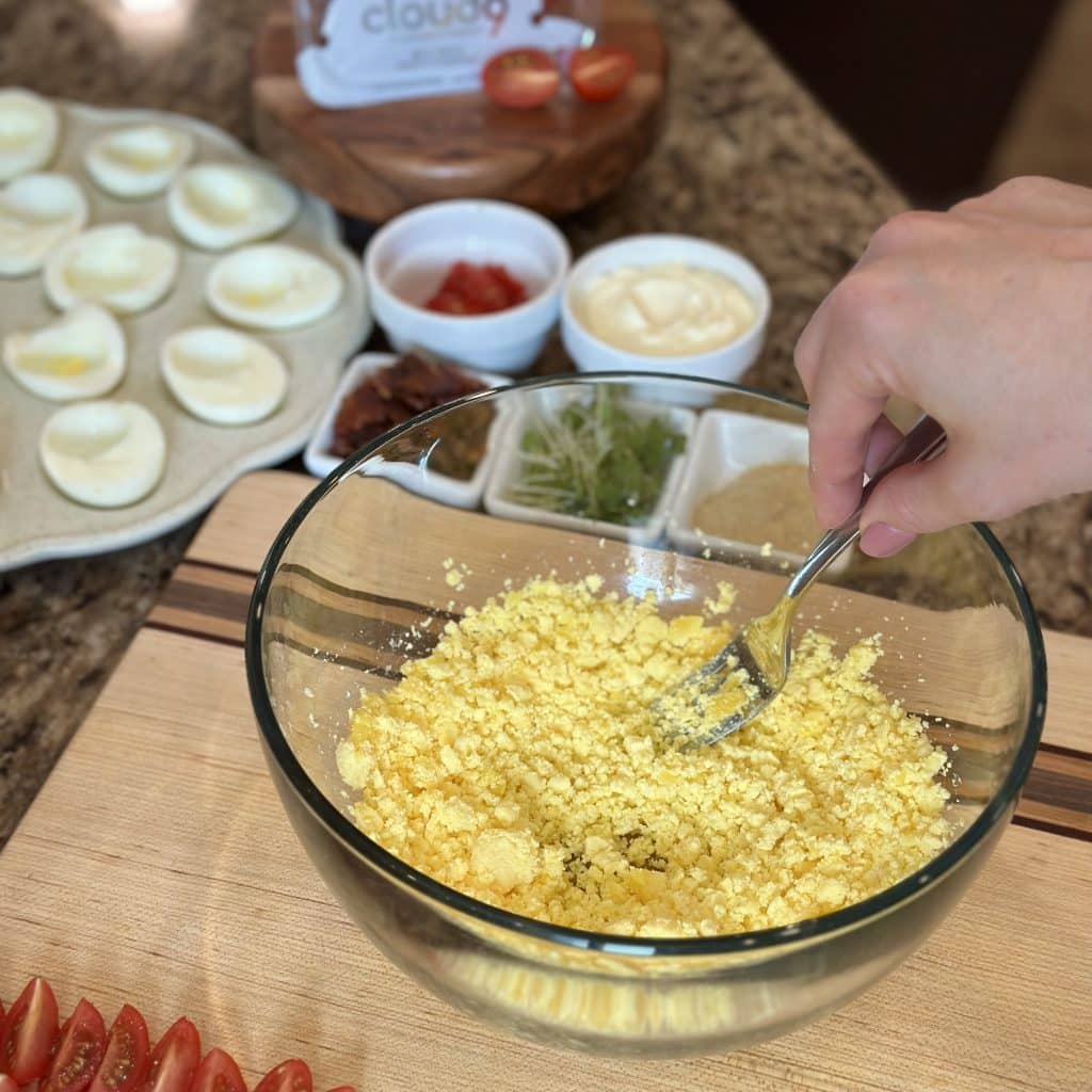 Mashing hardboiled egg yolks with a fork