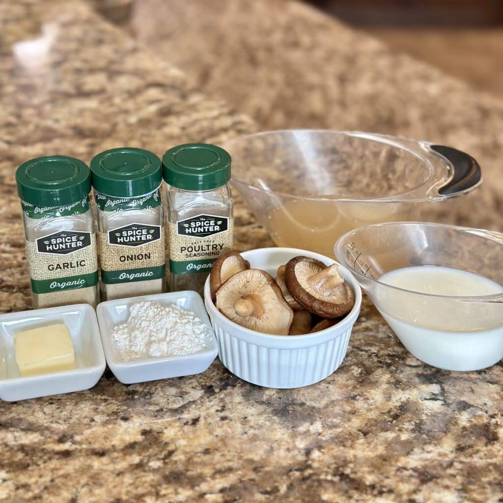 Ingredients to make cream of mushroom soup displayed on countertop