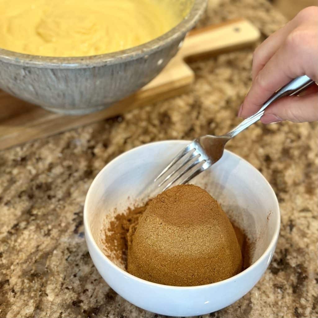 A brown sugar cinnamon filling being mixed in a small bowl.