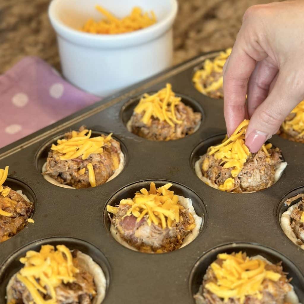 Sprinkling cheese on each barbecue cup