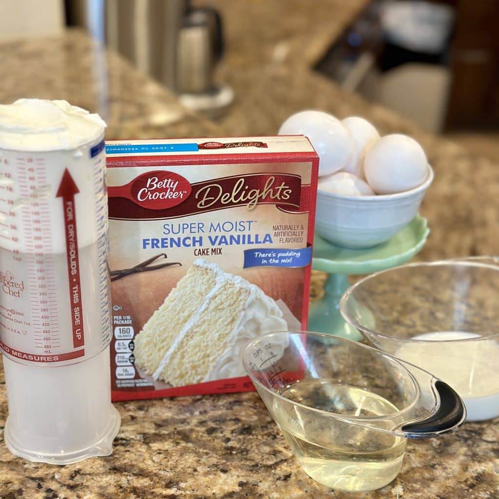 A vanilla cake mix and ingredients displayed on a table