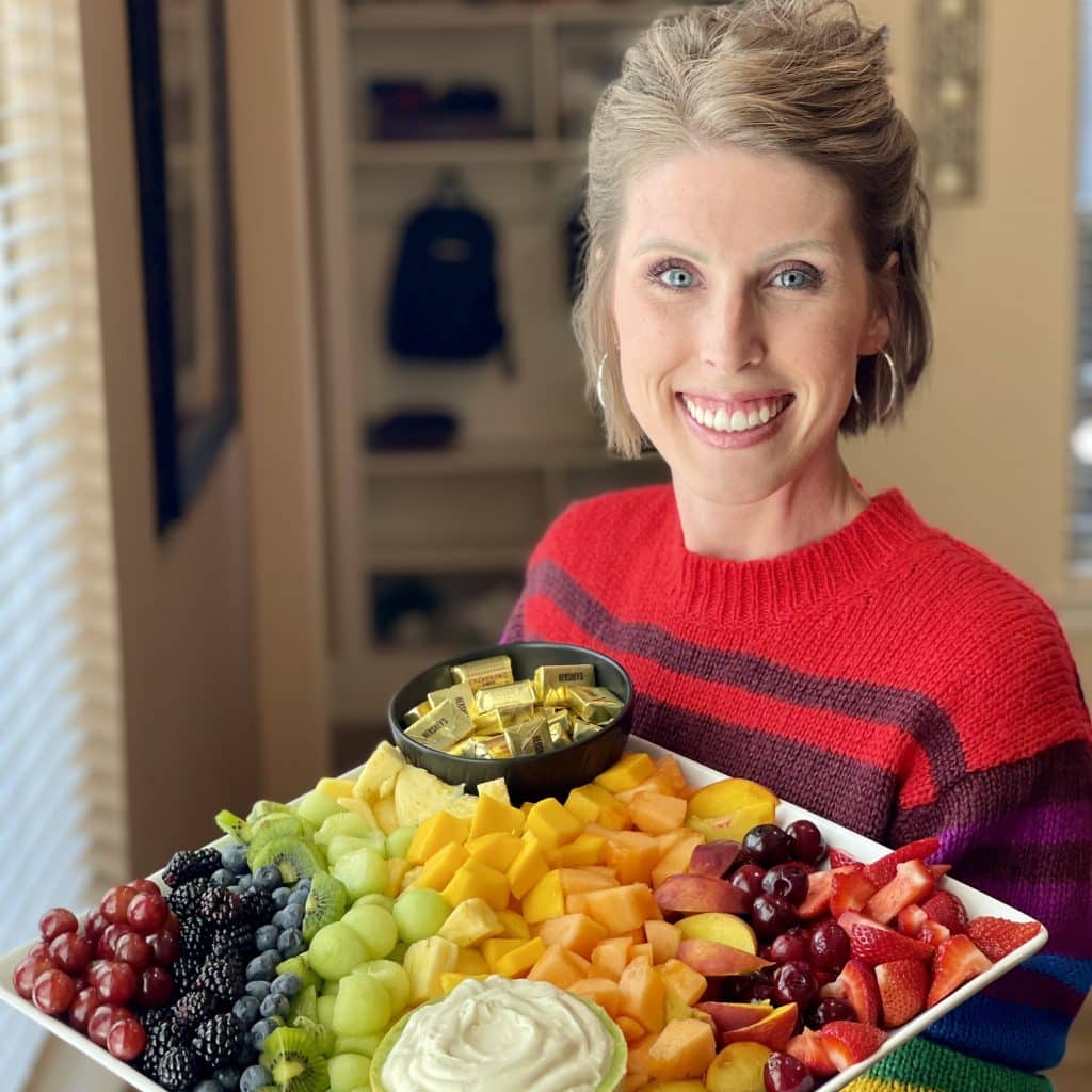 Laura holding a fruit tray.