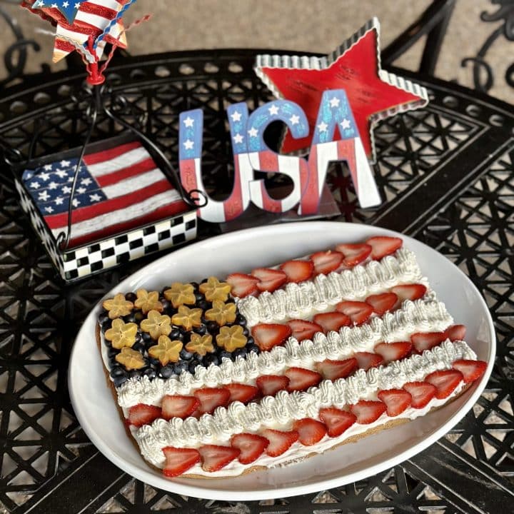 A cookie in the shape of and decorated like the American flag.