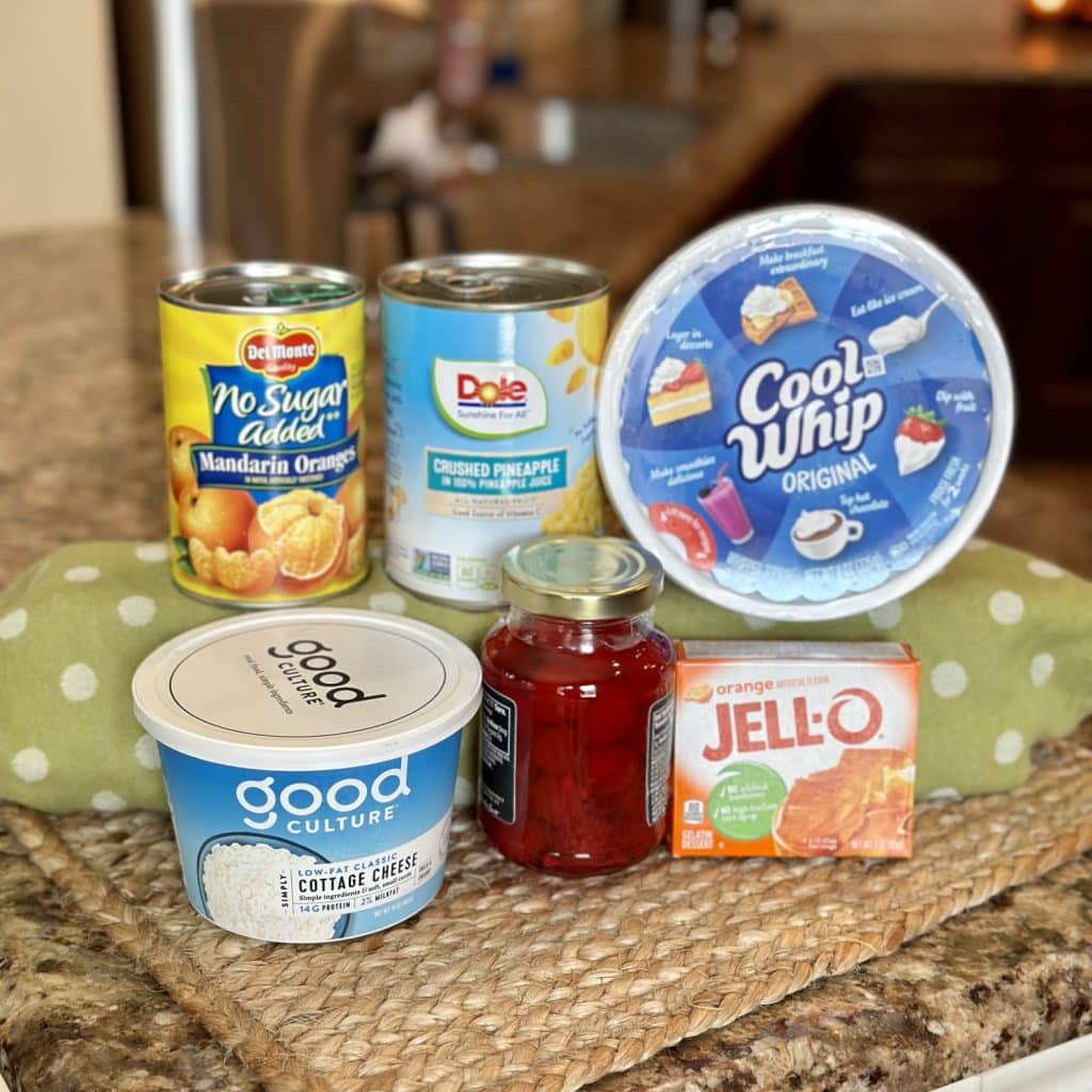 What you need to make orange Jell-O salad: Cool Whip, crushed pineapple, mandarin, oranges, maraschino, cherries, cottage, cheese, orange Jell-O.