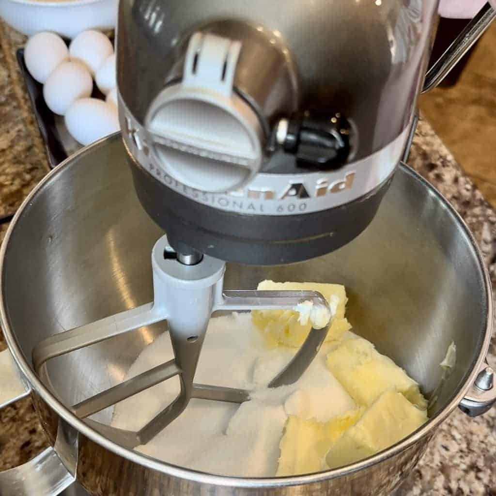 Butter and sugar in a stand mixer ready to be mixed.
