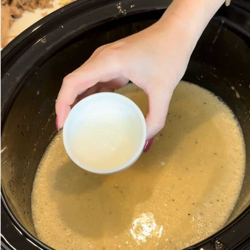 A cornstarch slurry being stirred in the crockpot.