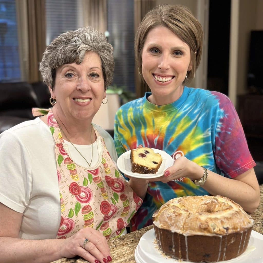 A picture of Laura and her mom with her mom's recipe, lemon blueberry pound cake, made and sliced.