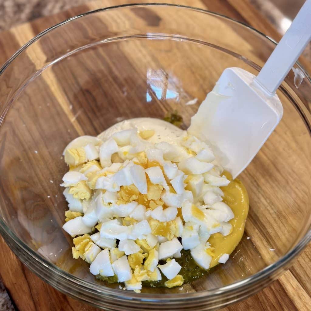 Mixing the ingredients for classic potato salad