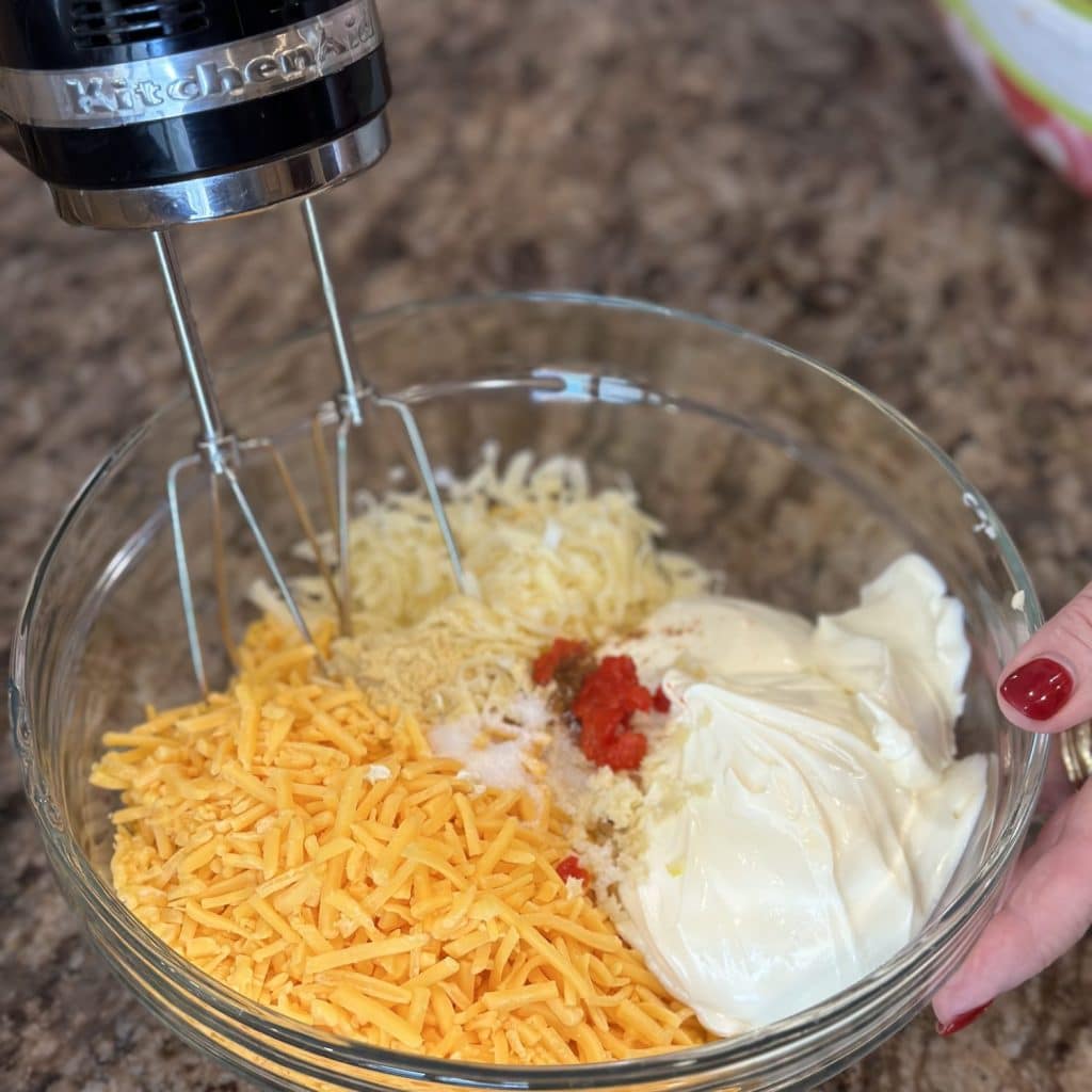 The ingredients to make pimento cheese in a bowl.