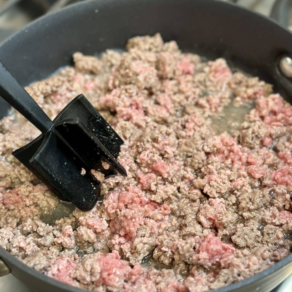 Ground beef being cooked in a skillet.