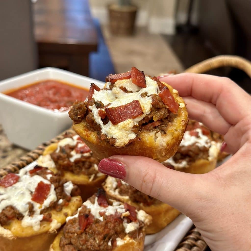 Pizza cups made with biscuit dough, filled with a meat and cheese filling and baked.