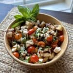A bowl of caprese panzanella salad.