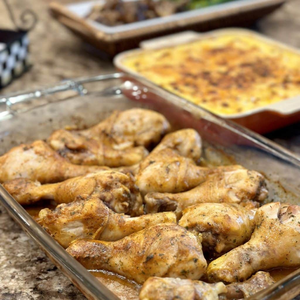 A completed dinner of baked drumsticks, mac & cheese and asparagus and mushrooms.