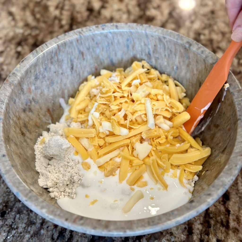 A bowl of biscuits mix and cheese.