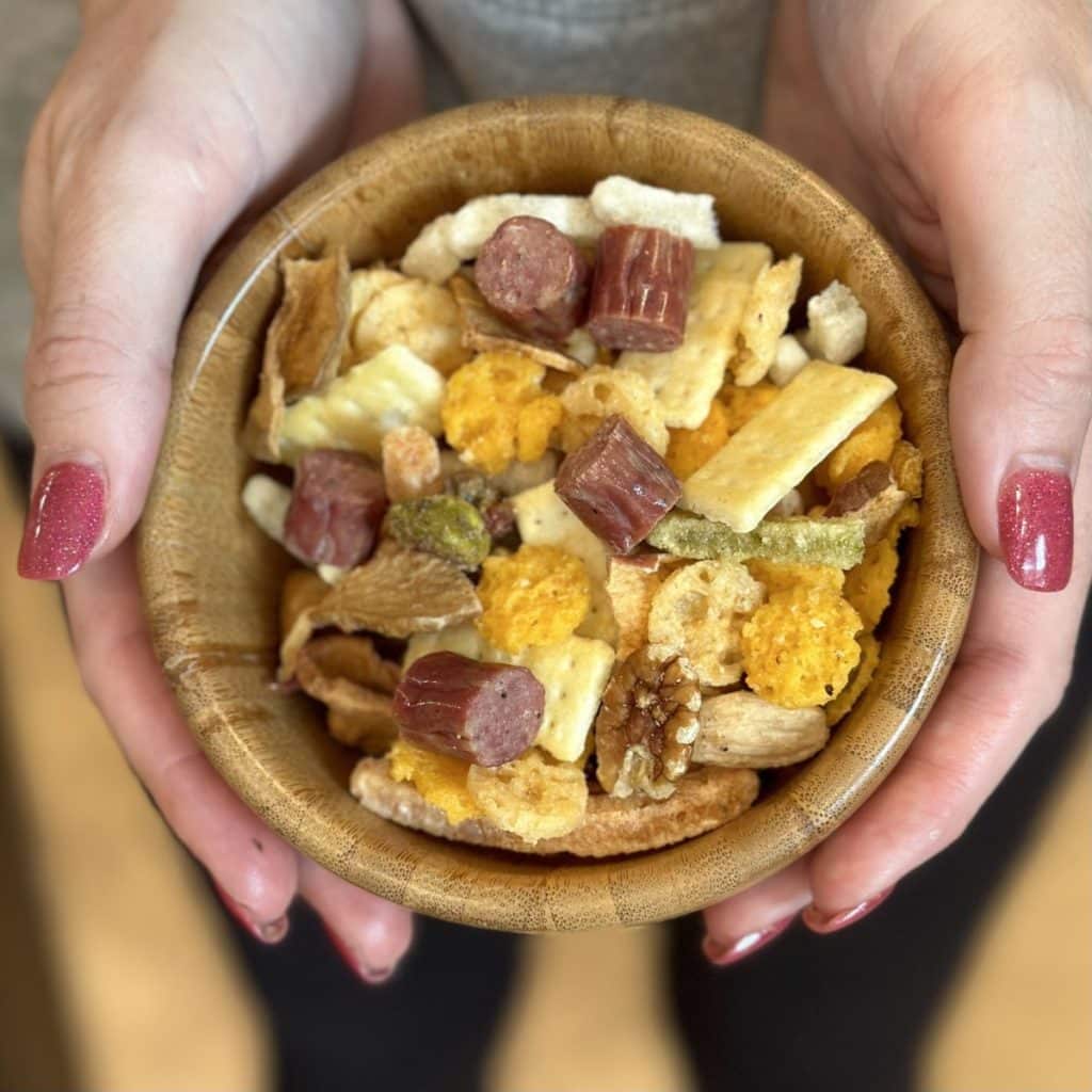 A small snack bowl of charcuterie party mix.