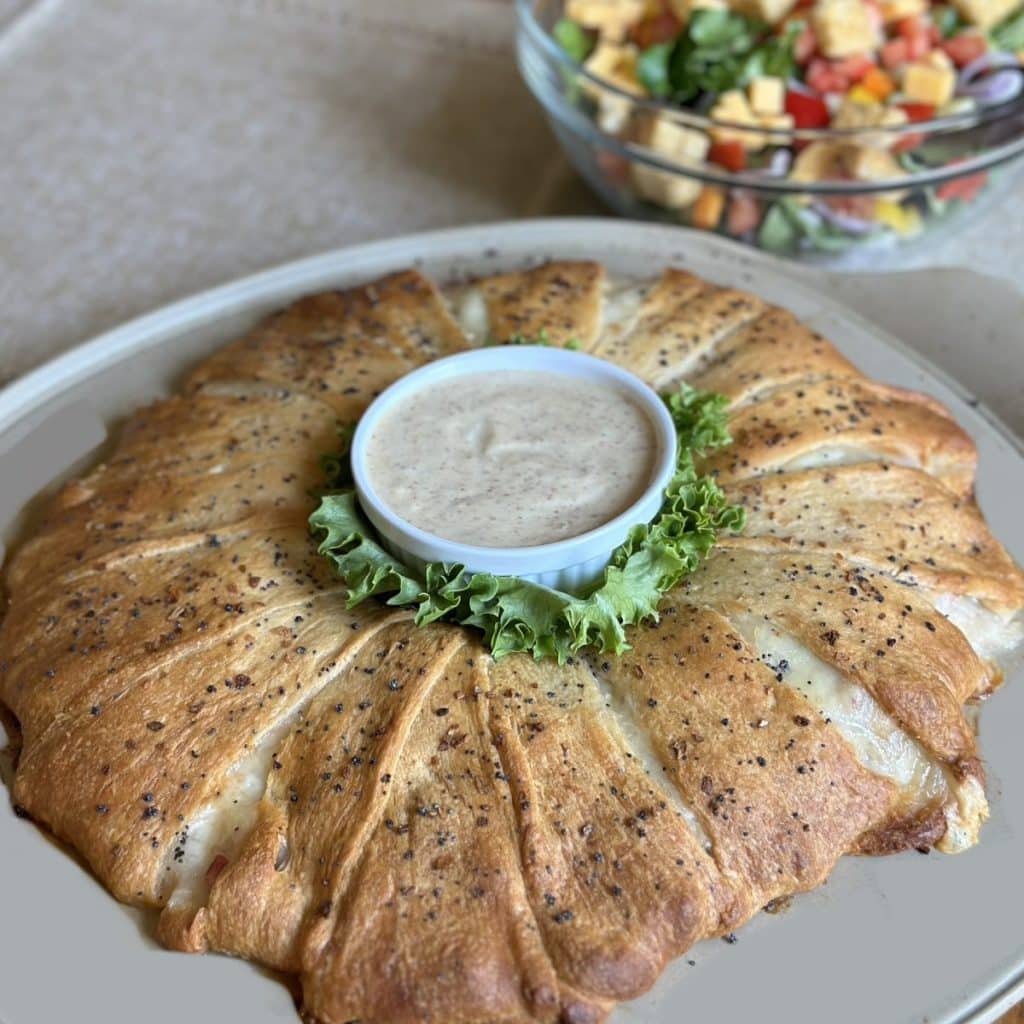 A baked ham and swiss crescent roll ring.